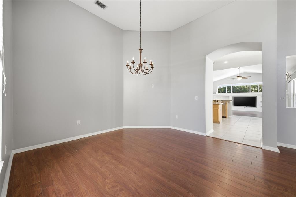 3209 Partridge Point Trail Valrico, FL 33596 - Photo 8 of 66 wooden floor in an empty room with a window
