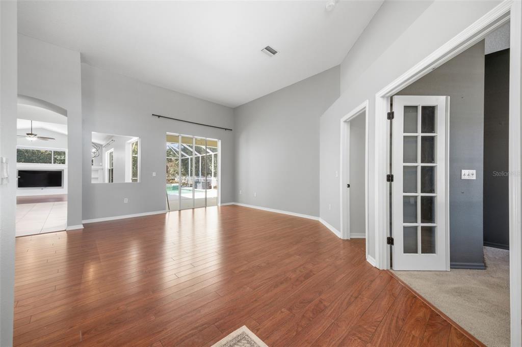 3209 Partridge Point Trail Valrico, FL 33596 - Photo 9 of 66 a view of an empty room with wooden floor and a window