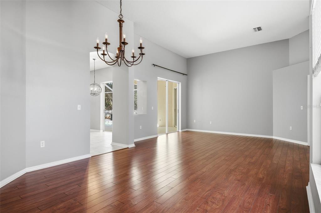 3209 Partridge Point Trail Valrico, FL 33596 - Photo 10 of 66 a view of an empty room with wooden floor and windows