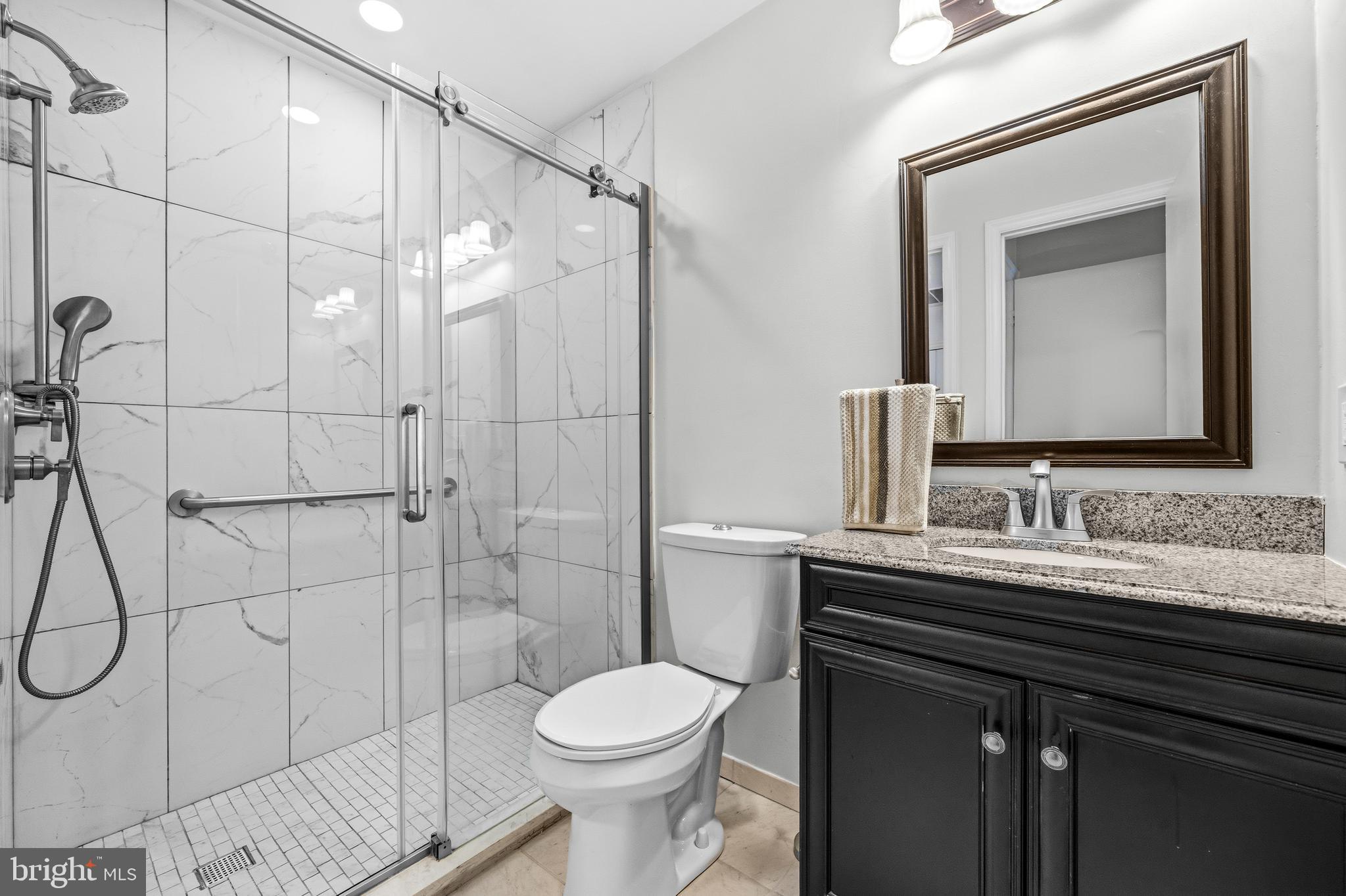 6001 Rabbit Hill Court Centreville, VA 20121 - Photo 24 of 46 a bathroom with a granite countertop sink toilet and shower