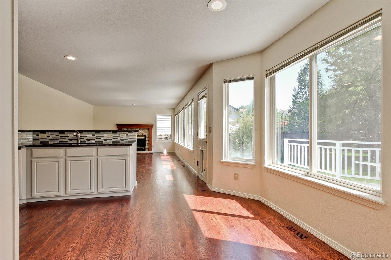 504 Rider Ridge Drive Longmont, CO 80504 - Photo 8 of 34 a view of a kitchen with wooden floor and a window