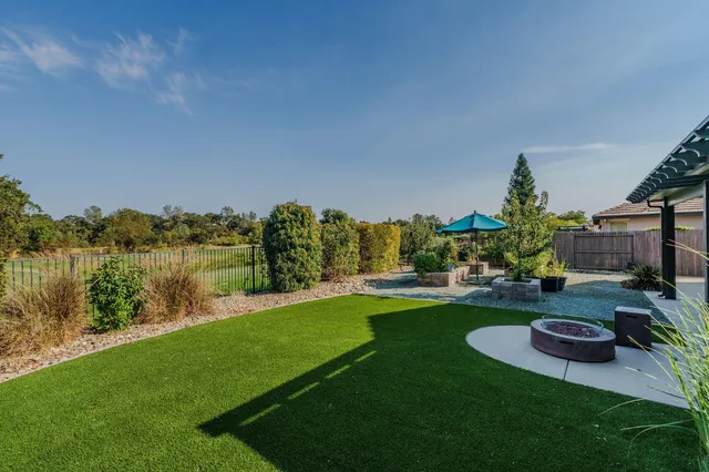 a living room with furniture a large window and a fireplace