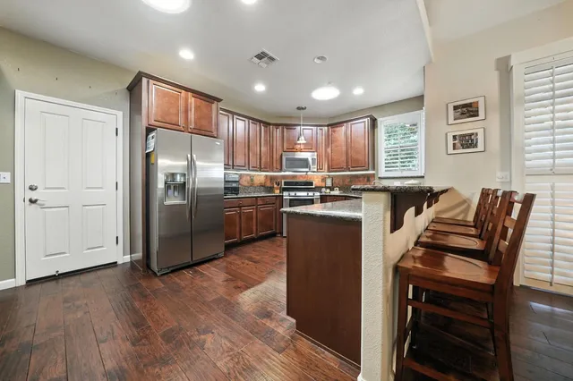 a living room with furniture a wooden floor and a window