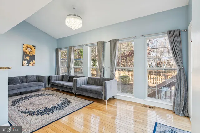 a kitchen with kitchen island granite countertop a sink a counter top space stainless steel appliances and cabinets