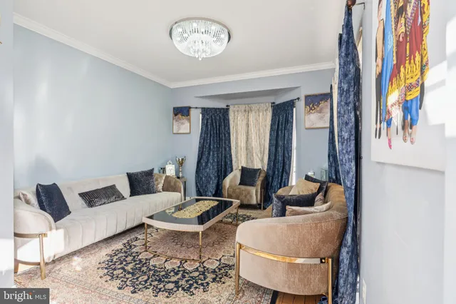 a bedroom with a bed table flowerpot and window