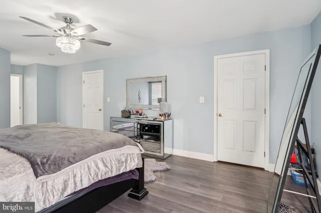a bathroom with a granite countertop sink a mirror a bathtub and shower