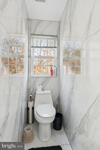 a spacious bedroom with a bed and a dresser