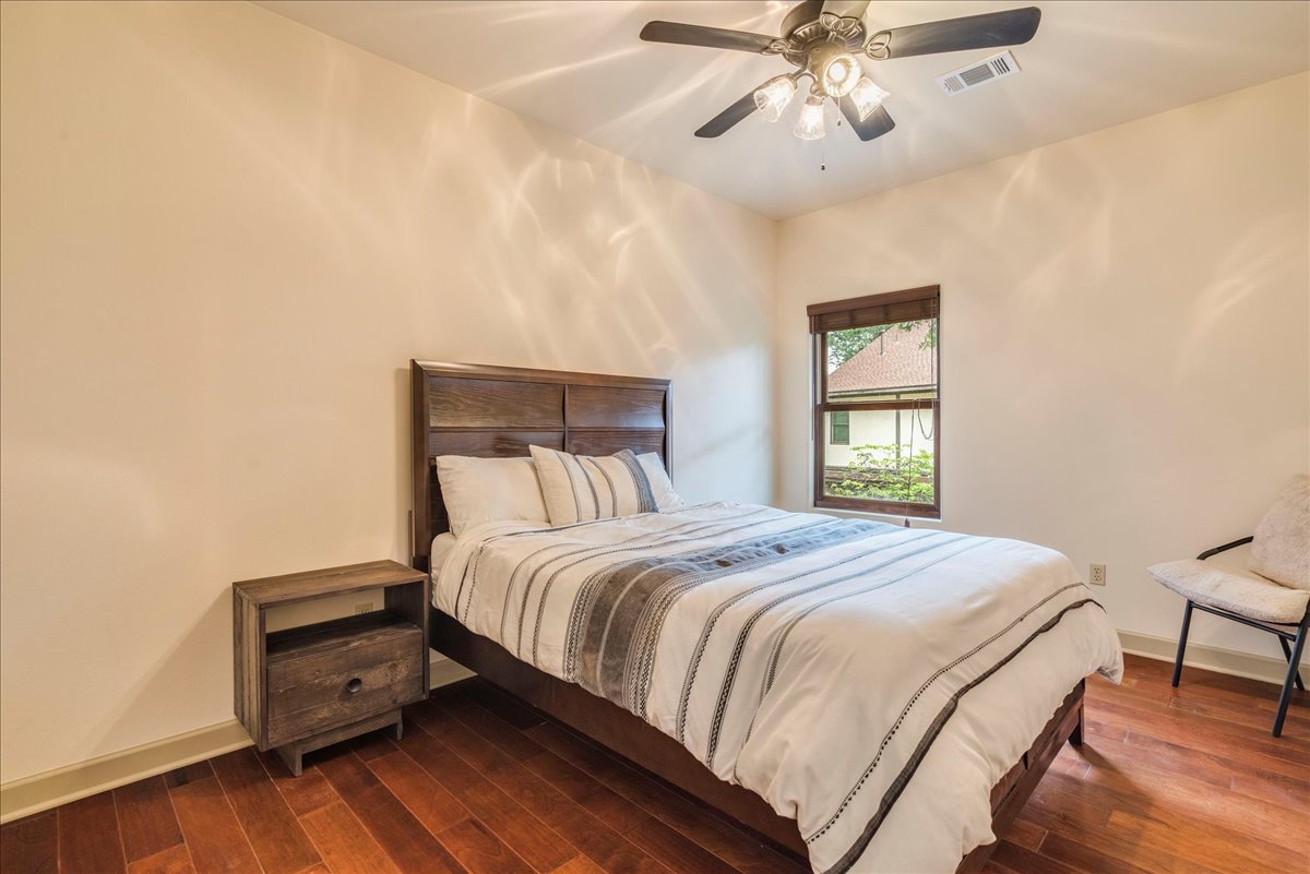 3012 South 4th Street, Unit B Austin, TX 78704 - Photo 19 of 40 Neutral-toned room featuring rich wood-finish flooring