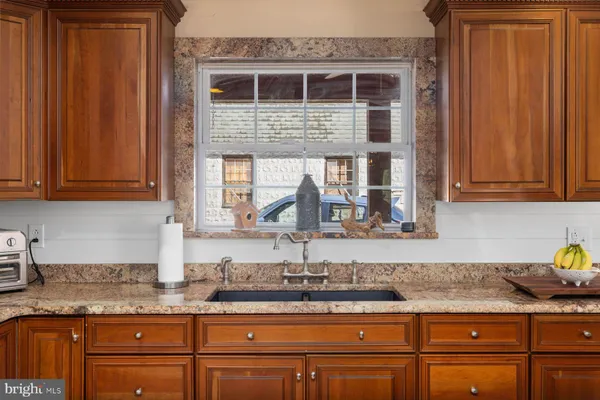 a kitchen with stainless steel appliances granite countertop a stove and a sink