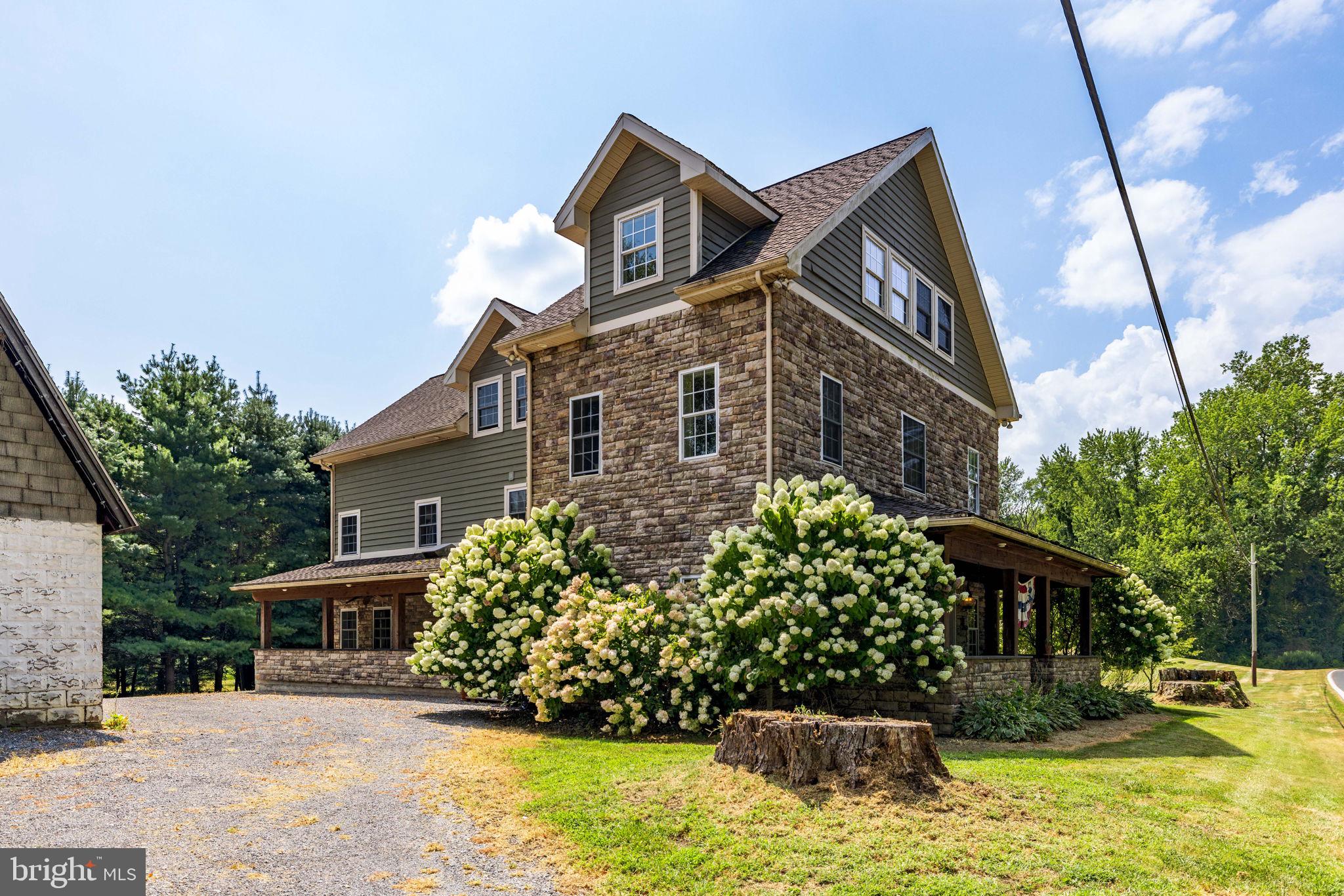 688 Sylvan Dell Road Williamsport, PA 17702 - Photo 2 of 73 a front view of a house with a yard and garage