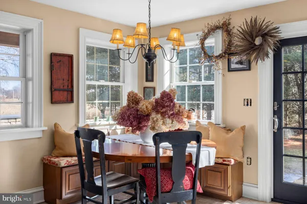 a living room with furniture a bookshelf and a window