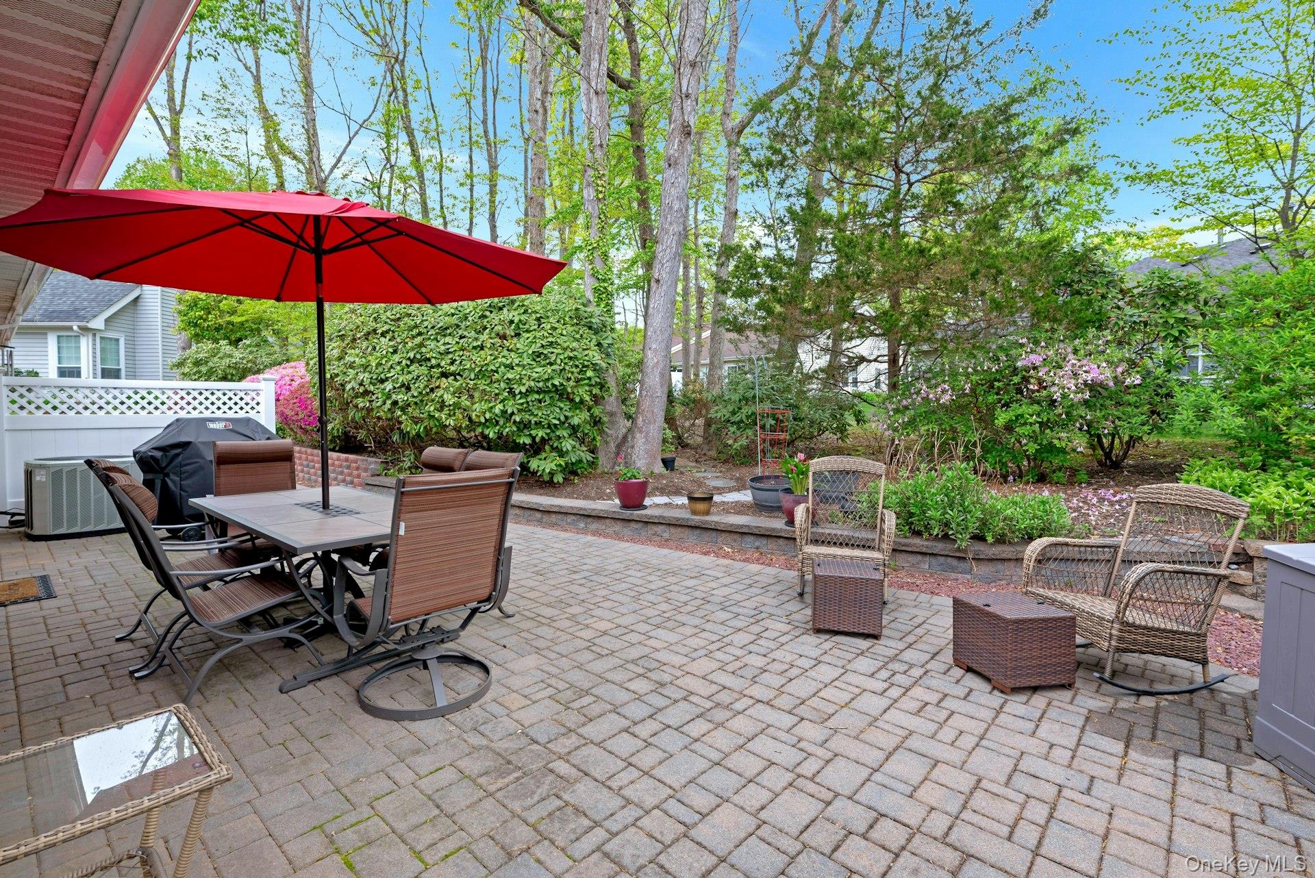 104 Glen Drive Ridge, NY 11961 - Photo 25 of 25 a view of a patio with chairs and table under an umbrella
