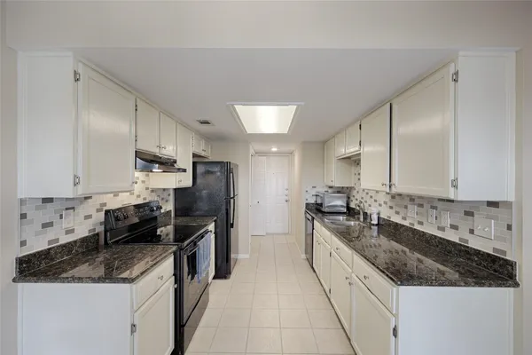 a large kitchen with a stove top oven