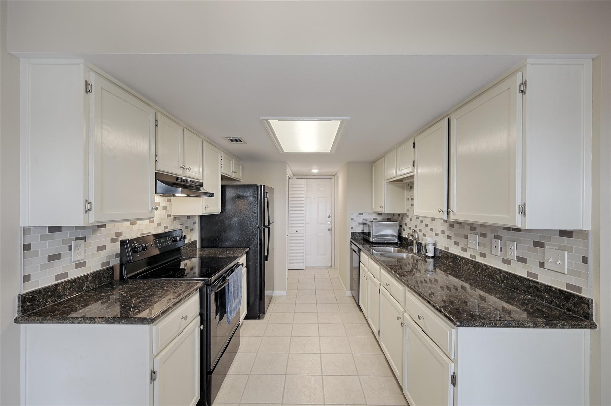 a large kitchen with a stove top oven