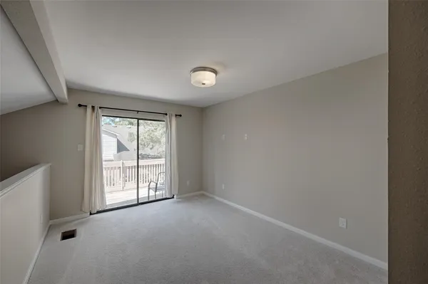 an empty room with windows and closet