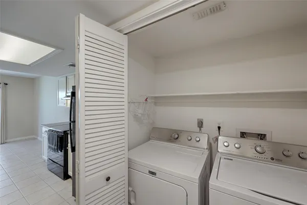 a view of storage and utility room with washer and dryer