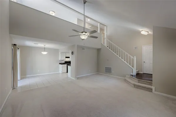 a view of an empty room with a ceiling fan