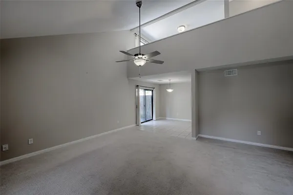 a view of a livingroom with a ceiling fan and window