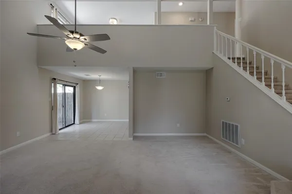 a view of a livingroom with a ceiling fan and window