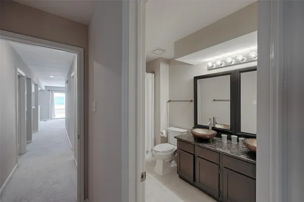 a bathroom with a double vanity sink and mirror