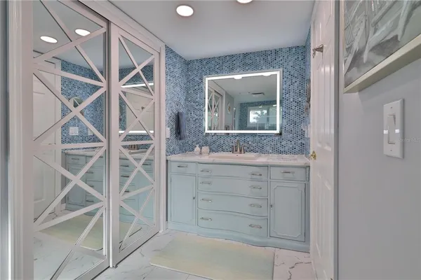 a bathroom with a granite countertop sink mirror and