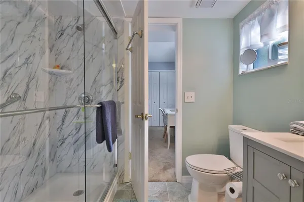 a white toilet sitting next to a bathroom sink