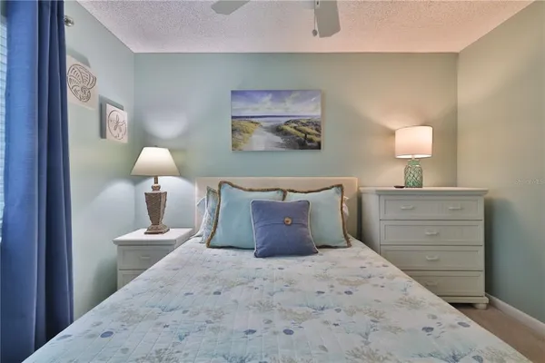 a bedroom with a bed and a lamp