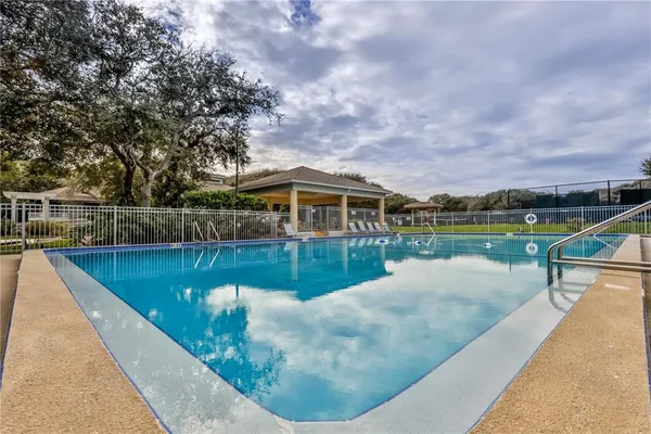 a swimming pool with outdoor seating and yard