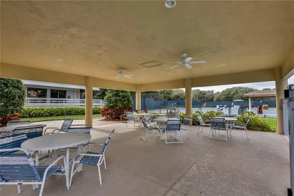 a view of a patio with dining table and chairs under an umbrella
