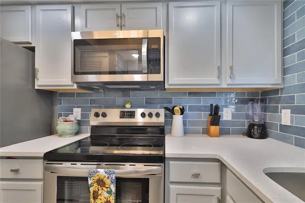 a kitchen with a stove and cabinets