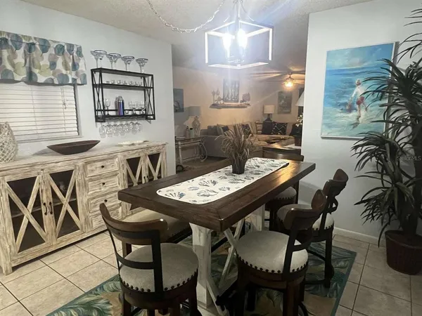 a view of a dining room with furniture and chandelier