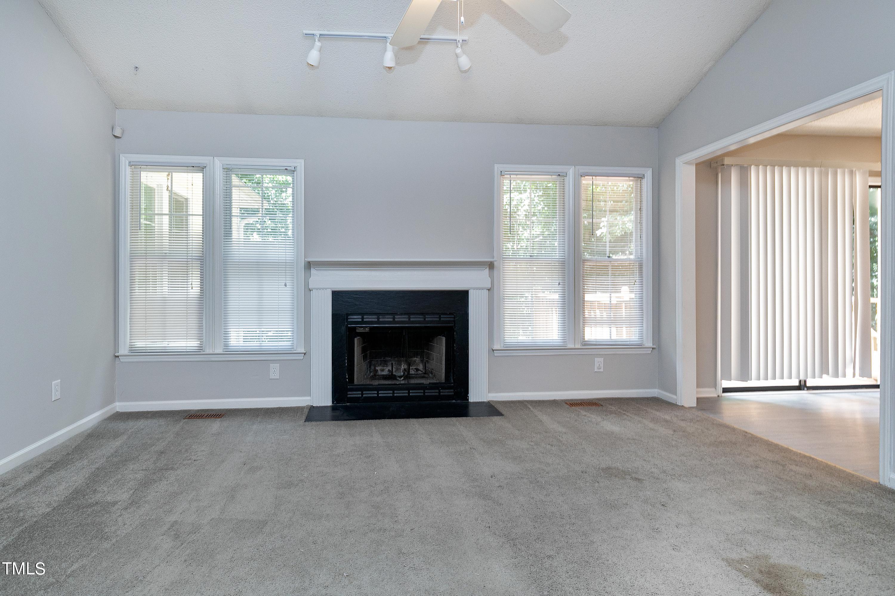 2313 Ruddy Road Raleigh, NC 27616 - Photo 11 of 32 an empty room with windows and fireplace