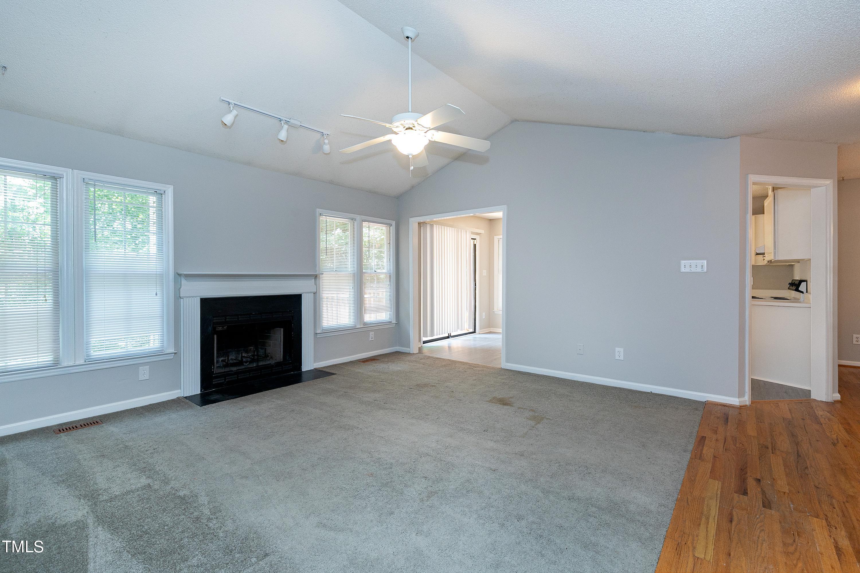 2313 Ruddy Road Raleigh, NC 27616 - Photo 12 of 32 an empty room with windows and fireplace