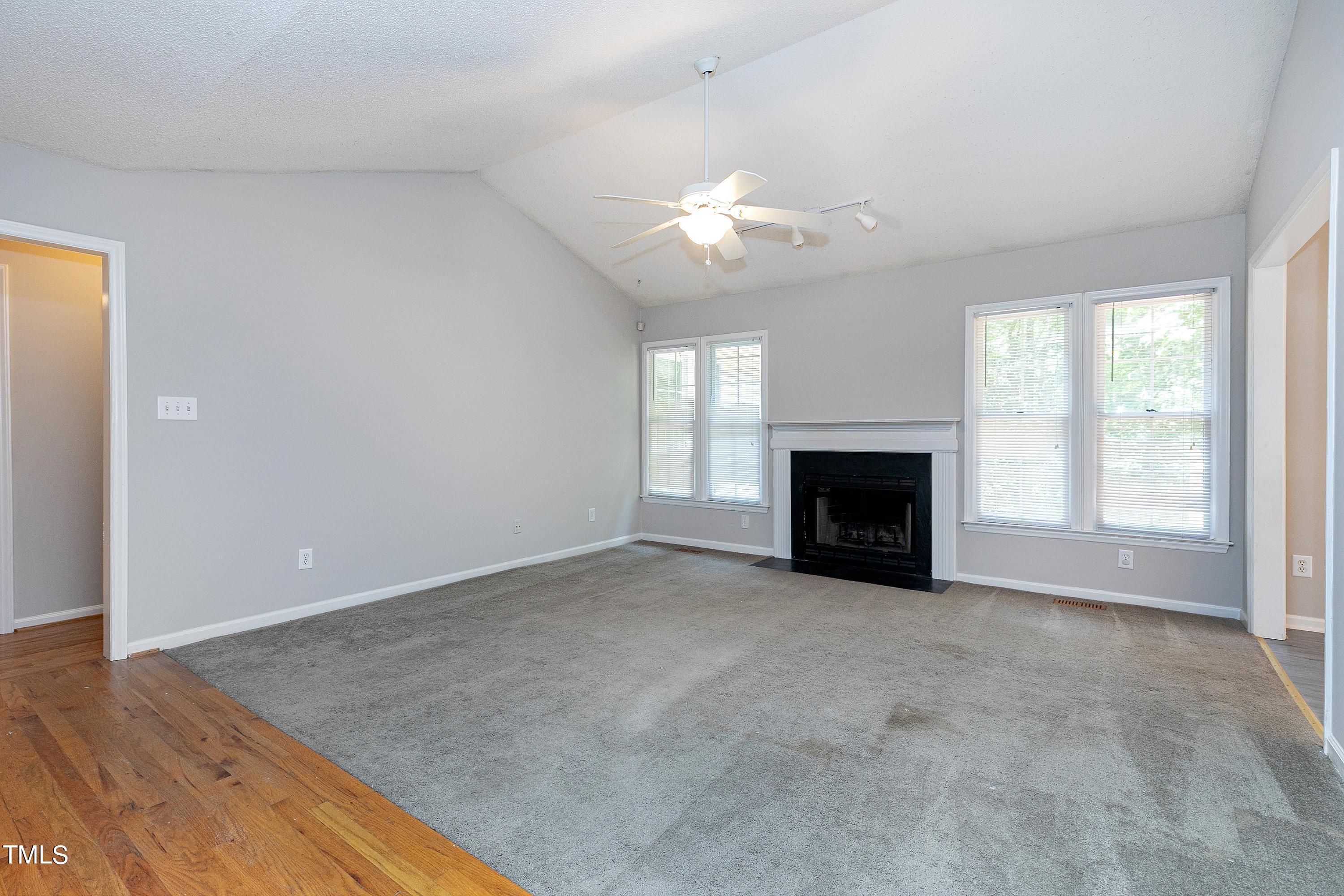 2313 Ruddy Road Raleigh, NC 27616 - Photo 13 of 32 an empty room with windows fireplace and a sink