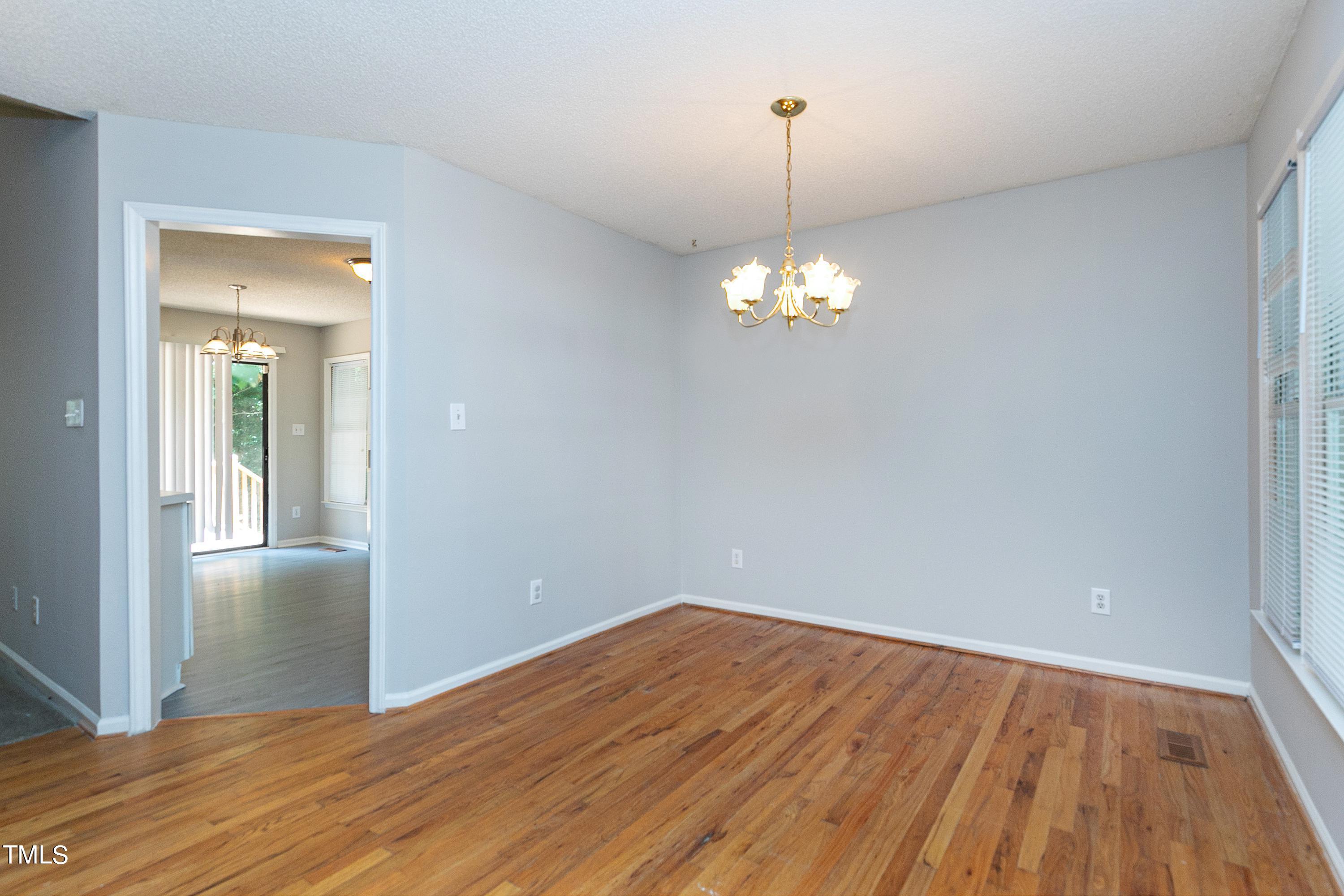 2313 Ruddy Road Raleigh, NC 27616 - Photo 14 of 32 a view of a room with wooden floor and chandelier