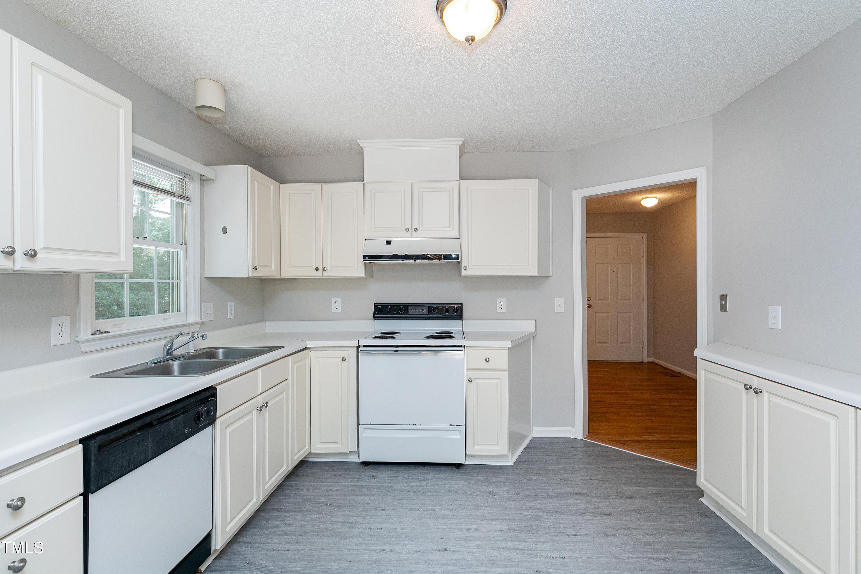 2313 Ruddy Road Raleigh, NC 27616 - Photo 18 of 32 a kitchen with a sink stove and cabinets