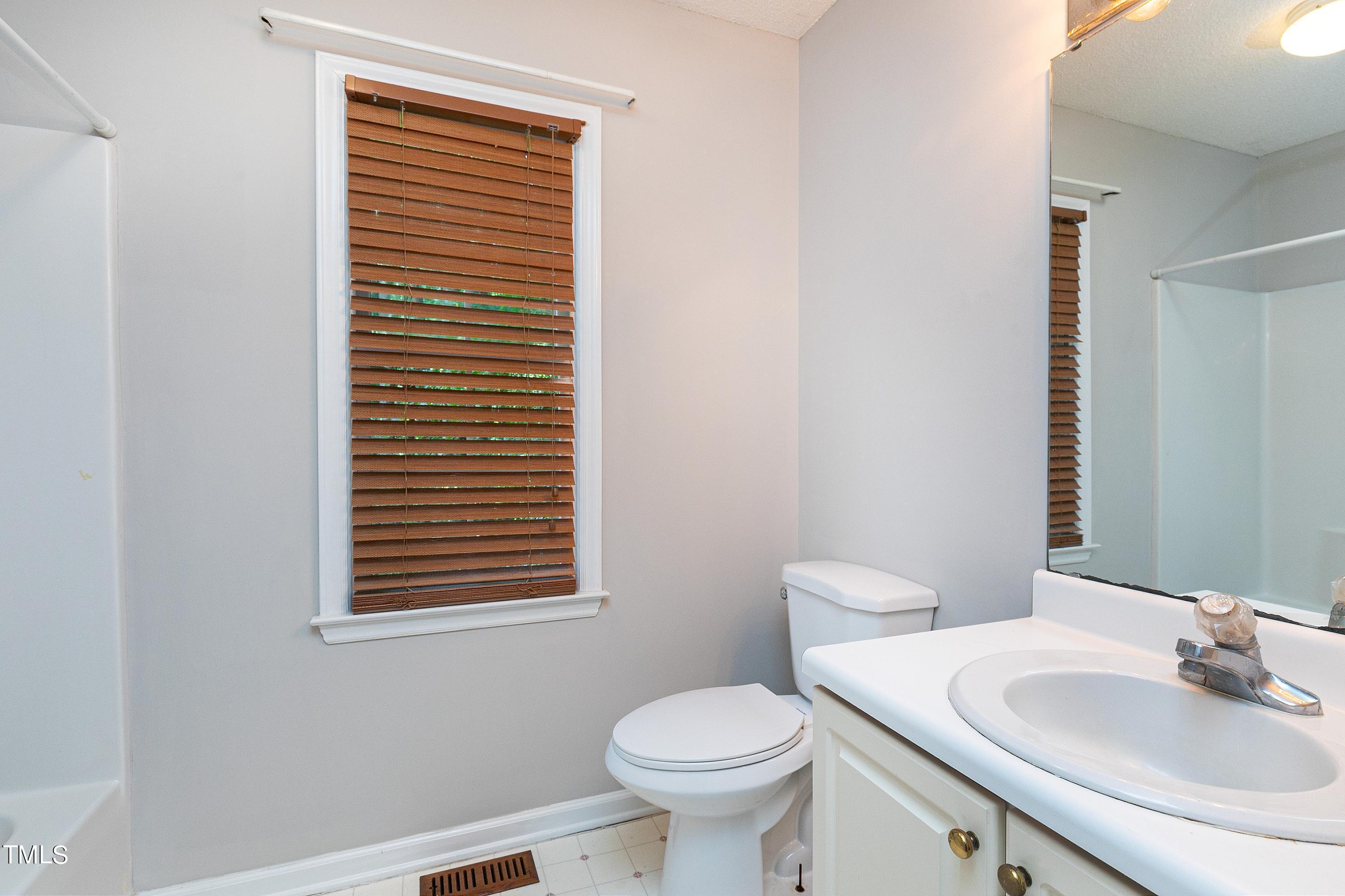 2313 Ruddy Road Raleigh, NC 27616 - Photo 21 of 32 a bathroom with a toilet sink and mirror