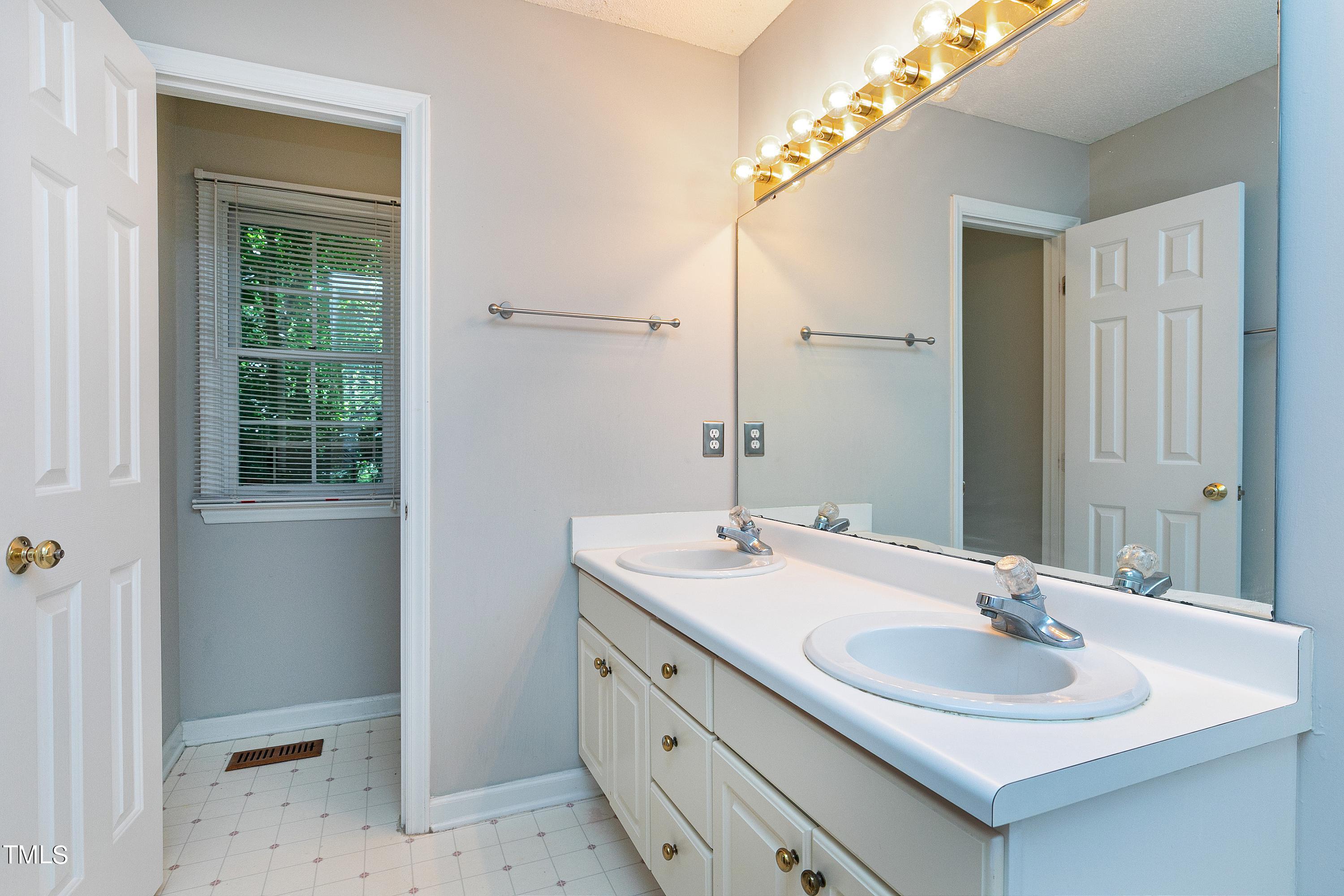 2313 Ruddy Road Raleigh, NC 27616 - Photo 22 of 32 a bathroom with a sink and a mirror