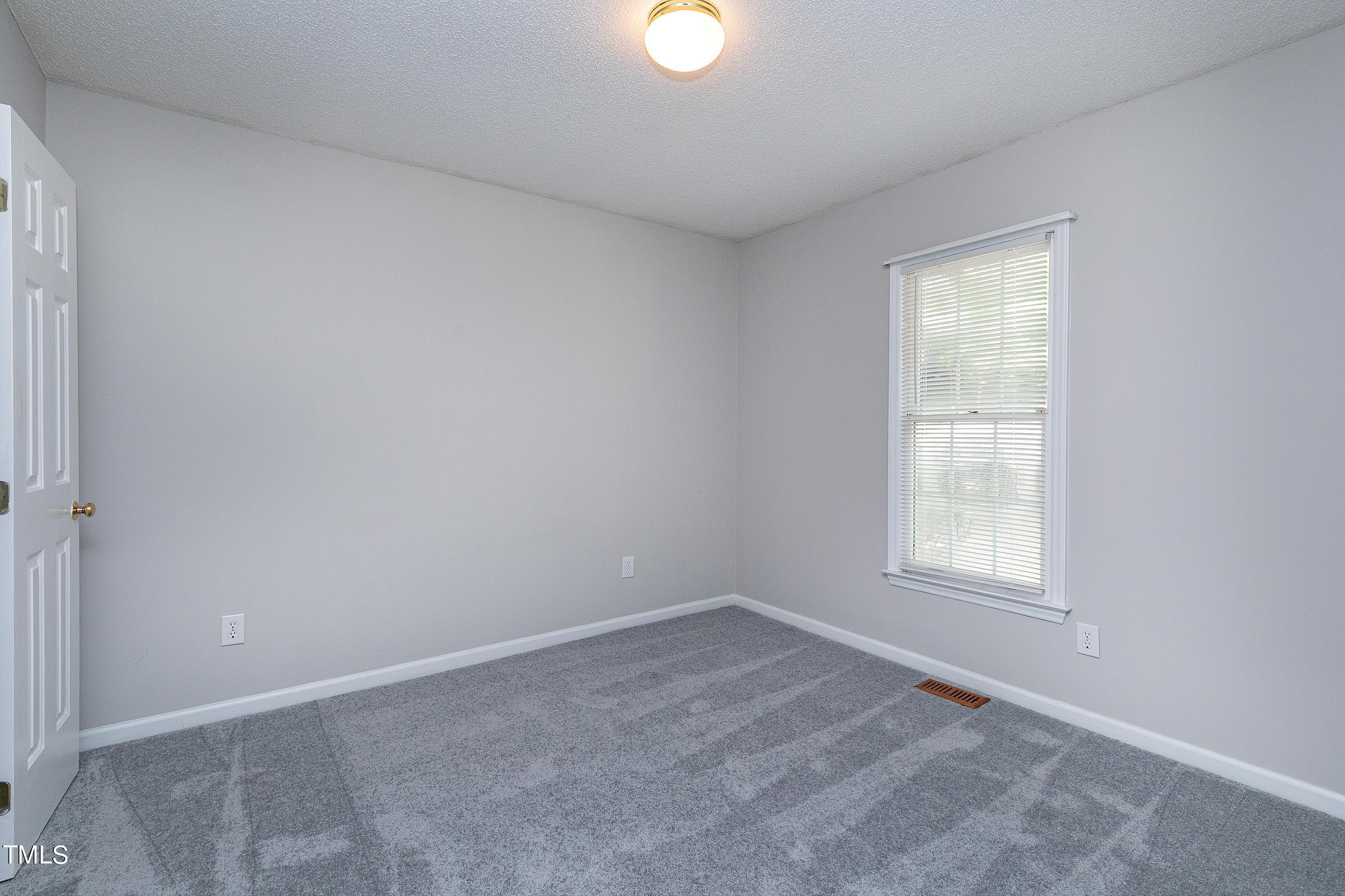 2313 Ruddy Road Raleigh, NC 27616 - Photo 27 of 32 an empty room with windows and with yard