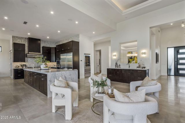a living room with furniture and a floor to ceiling window