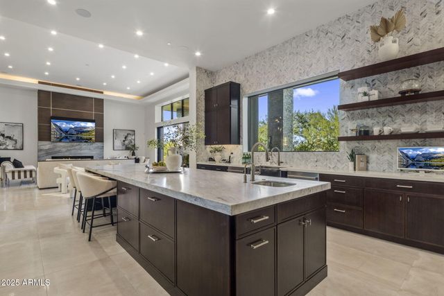 a bedroom with a large bed and a painting on the wall