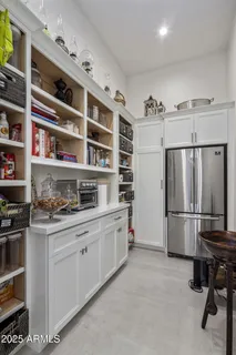 a kitchen with refrigerator cabinets and window