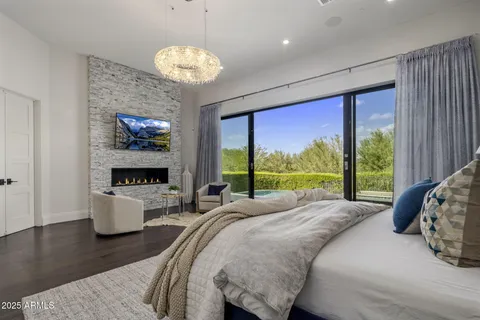 a bed sitting in a spacious bedroom next to a window