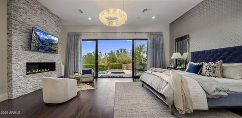 a spacious bedroom with a large bed and a fireplace