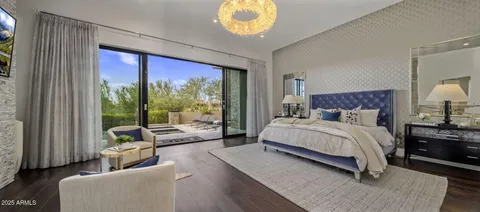 a bedroom with a bed and a large window