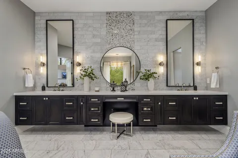a bathroom with a double vanity sink and a large mirror