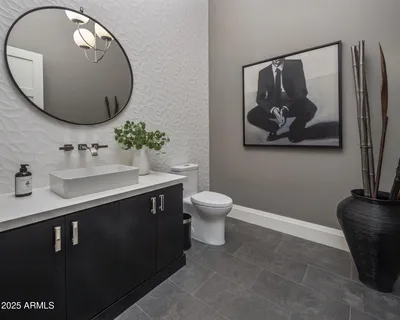 a bathroom with a sink mirror and toilet
