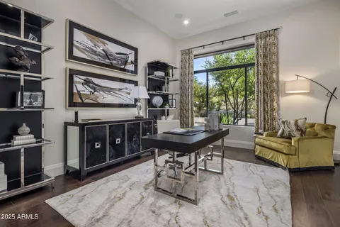 a living room with furniture and a floor to ceiling window