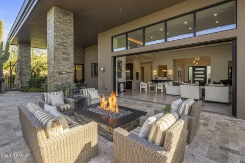 a view of a patio with couches chairs and a potted plant