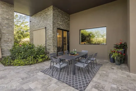 a view of a patio with table and chairs with wooden floor and fence